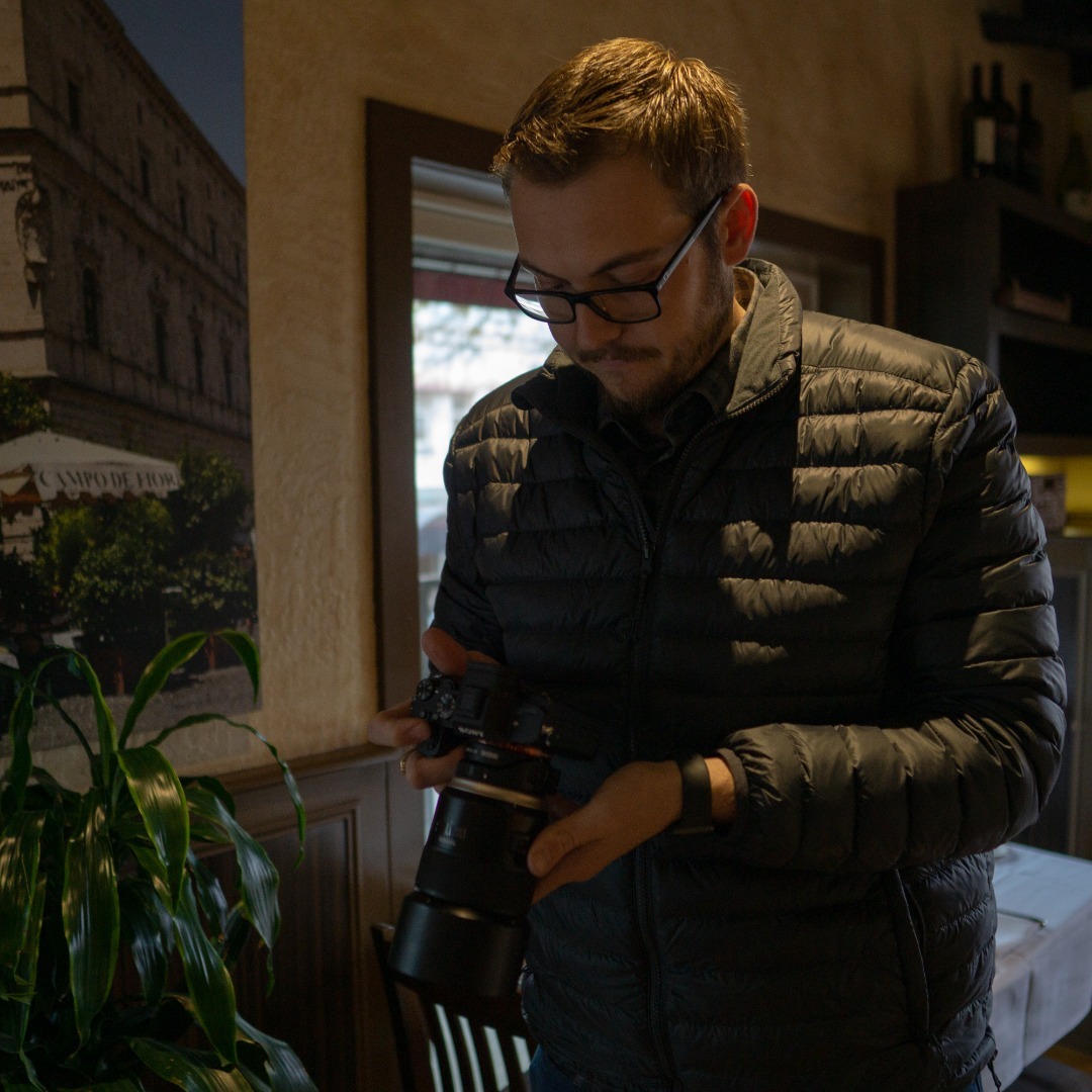Kyle reviewing a shot on a Sony mirrorless