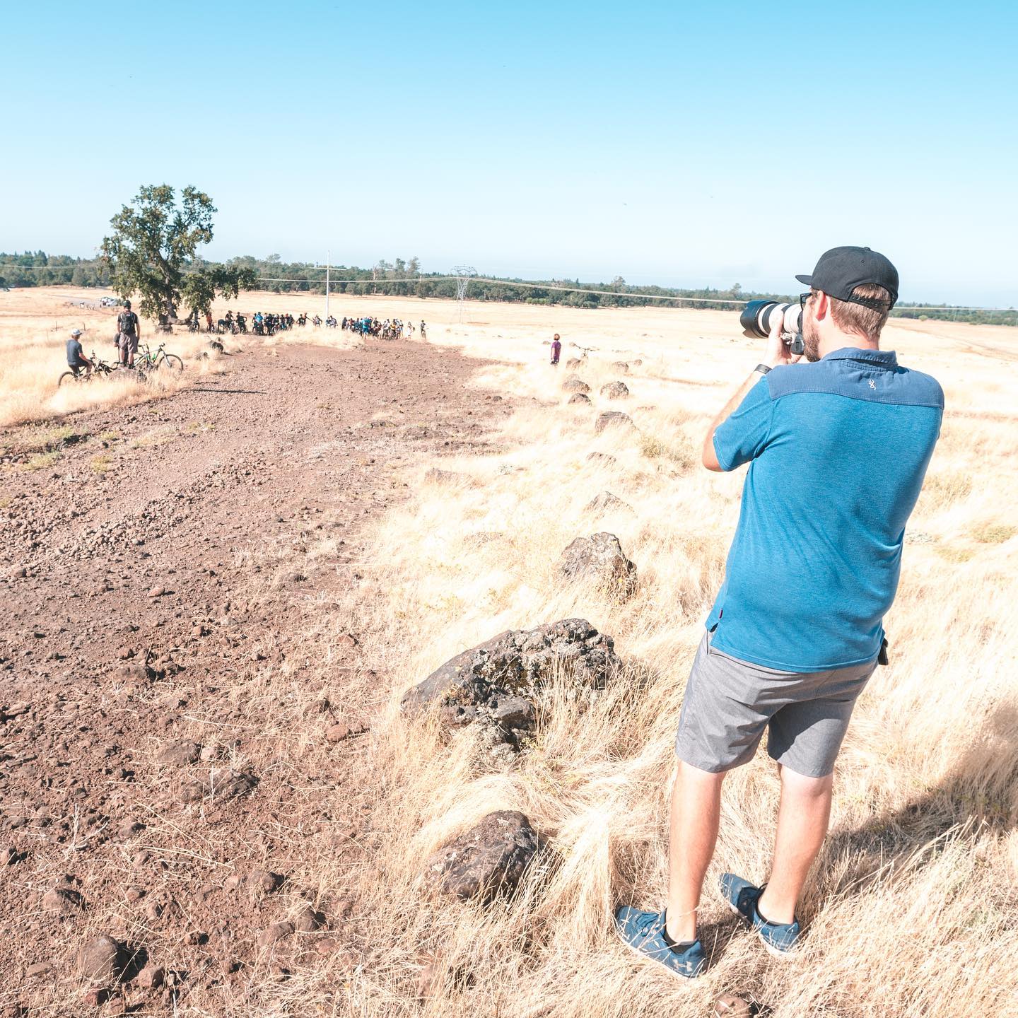 Kyle shooting a mountain bike event with a long lens